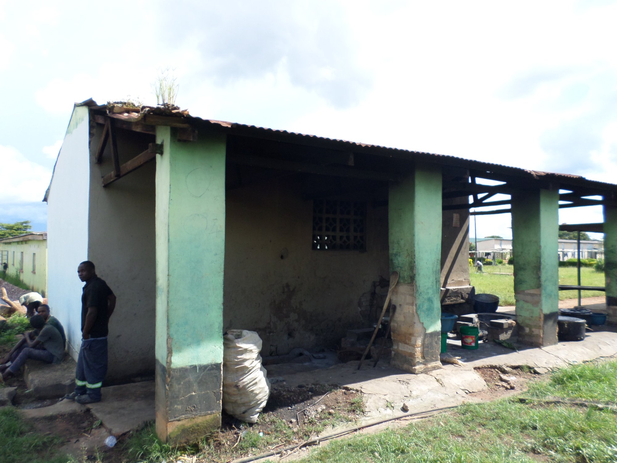 Full view of the deteriorated kitchen and dining area
